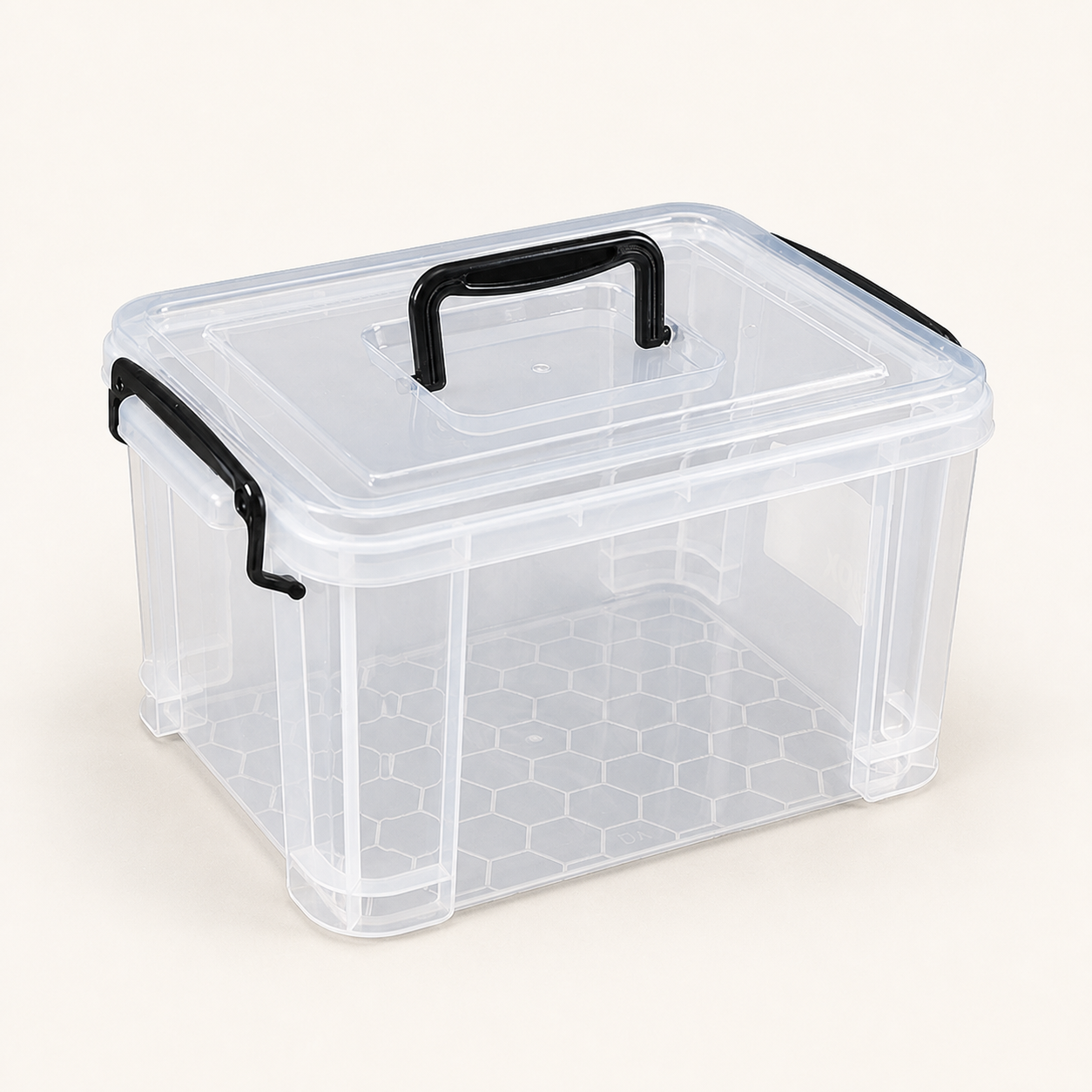 Clear plastic storage box with lid and black carry handles on a warm off-white background
